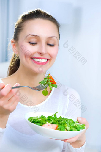 饮食健康的年轻的女人吃蔬菜沙拉