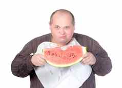 肥胖男人。吃西瓜