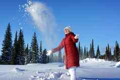 女孩抛出雪阳光明媚的下午