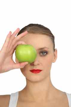 女人持有绿色苹果眼睛