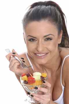 模型发布年轻的女人吃新鲜的水果沙拉