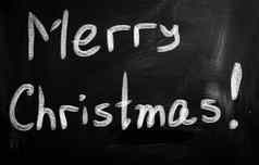 快乐圣诞节手写的白色粉笔黑板上