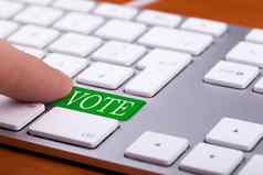 手指紧迫的投票绿色按钮键盘