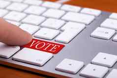 手指紧迫的投票红色的按钮键盘
