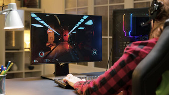 女人耳机坐着游戏椅子玩视频游戏电脑