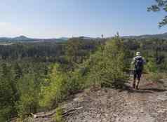 回来男人。徒步旅行者走景观劳济茨人的山视图砂岩岩石绿色山新鲜的落叶云杉树森林蓝色的天空背景水平复制空间