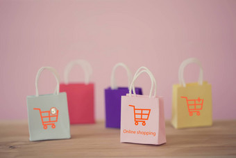 购物在线电子商务概念纸购物袋购物<strong>车图标</strong>表格在线商店被认为是媒介交易货物企业家客户