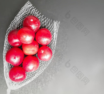色彩斑斓的红色的李子水果封面黑色的背景减少风险癌症心疾病糖尿病