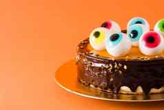 万圣节蛋糕糖果眼睛装饰孤立的橙色背景