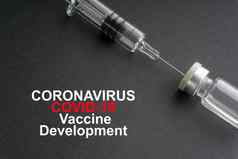 冠状病毒科维德疫苗发展文本注射器瓶黑色的背景