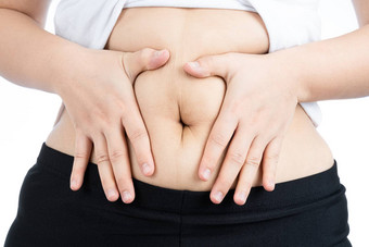 脂肪女人持有过度脂肪肚子超重高脂肪的肚子孤立的白色背景饮食生活方式重量损失胃肌肉健康的概念
