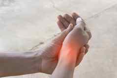 特写镜头手亚洲男人。痛苦手腕疼痛锻炼左手持有手橙色光使现实的真正的在户外健康护理概念