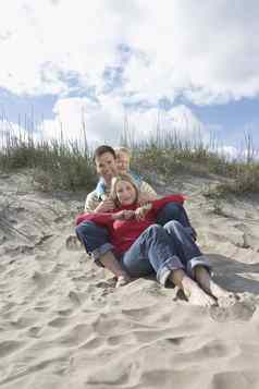父母女儿拥抱海滩肖像