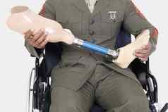 上腹部军事官持有假肢腿坐在轮椅