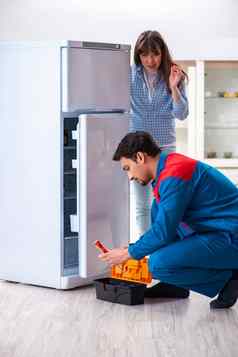 男人。修复冰箱客户