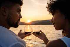 浪漫的特写镜头混合比赛夫妇烤面包眼镜红色的酒交叉光设置太阳湖