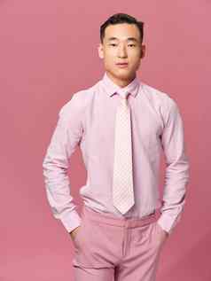 优雅的男人。衬衫领带有吸引力的时尚粉红色的背景