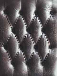 皮革沙发capitone切斯特菲尔德技术家具室内装潢黑暗优雅的家具阁楼织物背景自然变形背景
