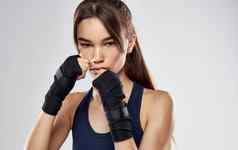 女人拳击手手套灰色的背景裁剪视图浅黑肤色的女人模型