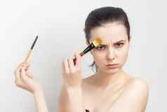浅黑肤色的女人刷牙奶油脸皮肤护理裁剪视图