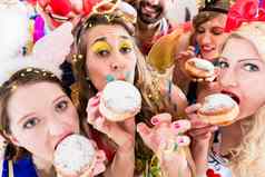 狂欢节聚会，派对人吃甜甜圈