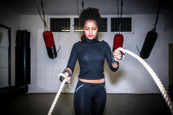年轻的适合女人锻炼战斗绳子功能培训