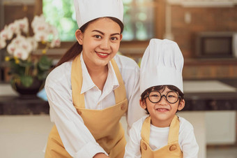 肖像可爱的亚洲男孩老板眼镜妈妈。相机首页烹饪厨房幸福的有趣的人生活方式家庭自制的食物成分使概念