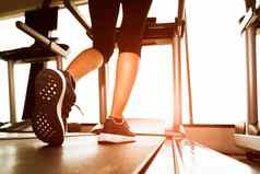 回来视图较低的身体腿健身女孩运行机跑步机健身健身房太阳雷温暖的语气健康的锻炼活动概念锻炼强度培训主题