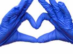 医生的手使心形状蓝色的保护乳胶手套孤立的白色科维德保护冠状病毒