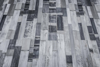 黑暗灰色地板上木表面木条镶花之地板层压板纹理背景