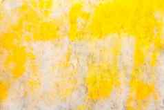 黄色的明亮的油漆点模式光大理石摘要墙纹理背景