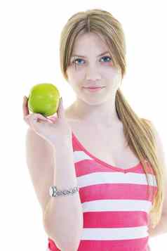 快乐年轻的女人吃绿色苹果孤立的白色