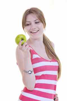 快乐年轻的女人吃绿色苹果孤立的白色