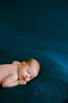 肖像婴儿睡觉蓝色的毯子肚子