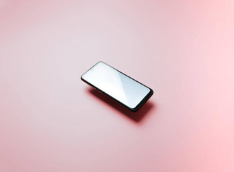 前视图移动电话浮动空白小石子模板柔和的粉红色的背景复制空间最小的设计形状色彩斑斓的