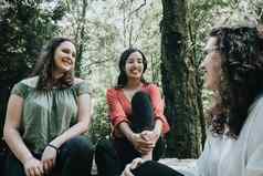 年轻的女人会说话的森林参加朋友护理友谊概念爱讨论