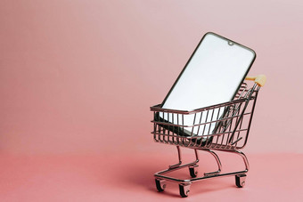 购物车空白移动电话柔和的粉红色的背景商务在线购买在线商务背景技术购物一天黑色的星期五网络复制空间模拟