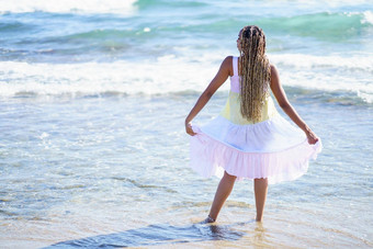 黑色的女孩走海岸海滩穿美丽的长衣服