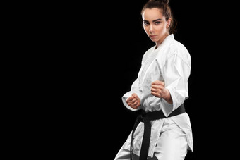肖像运动空手道跆拳道女人白色和服黑色的带黑暗背景