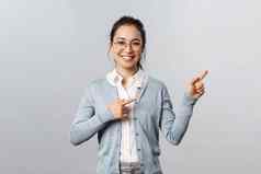 教育研究在线类概念快乐的亚洲女人老师指出手指演讲图表微笑友好的帮助找到显示促销灰色背景