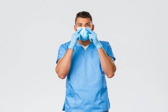 医疗保健工人科维德冠状病毒防止病毒概念年轻的护士医生蓝色的实习医生风云手套解释病人应用医疗面具系鼻子灰色背景