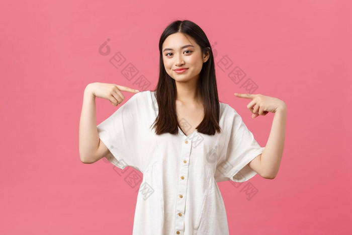 美人情绪夏天休闲假期概念自信时尚的亚洲女孩白色衣服微笑满意指出骄傲爱炫耀的人站粉红色的背景