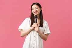 休闲人情绪生活方式概念快乐的微笑亚洲女孩卡拉ok享受周末唱歌首歌麦克风执行单口站粉红色的背景