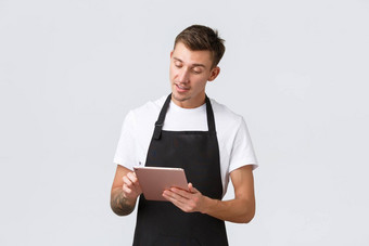 小业务咖啡商店咖啡馆员工概念英俊的年轻的的家伙咖啡师服务员采取订单服务表餐厅写作订单数字平板电脑白色背景