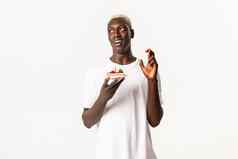 肖像充满希望的有吸引力的黑色的的家伙庆祝生日使持有生日蛋糕交叉手指梦想真正的白色背景