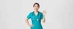科维德医疗保健工人流感大流行概念惊讶快乐亚洲女医生护士实习医生风云显示手势微笑惊讶赞美不错的工作同意