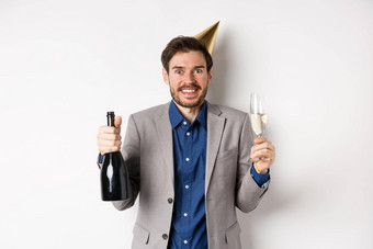 庆祝活动假期概念兴奋英俊的生日的家伙聚会，派对他微笑喝香槟有趣的白色背景