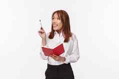 业务金融职业生涯概念成功的年轻的优雅的亚洲夫人白色衬衫使计划思考建筑图片心提高笔深思熟虑的持有红色的笔记本规划师