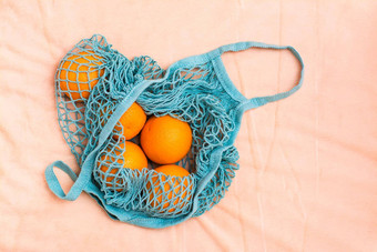 新鲜的橙子网袋织物背景浪费