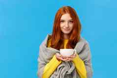 红色头发的人女孩温暖的感觉冷包装围巾肩膀喝热茶持有茶壶微笑可爱的站温柔的可爱的蓝色的背景